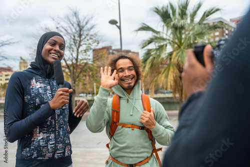 Reporter interviewing man for street journalism video