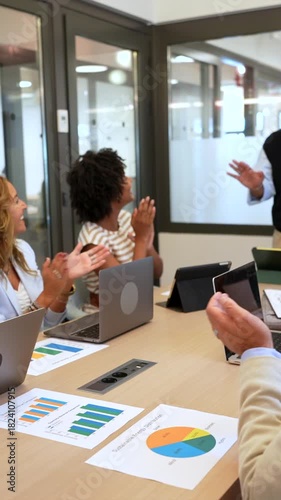 Colleagues applauding a successful business presentation in an office