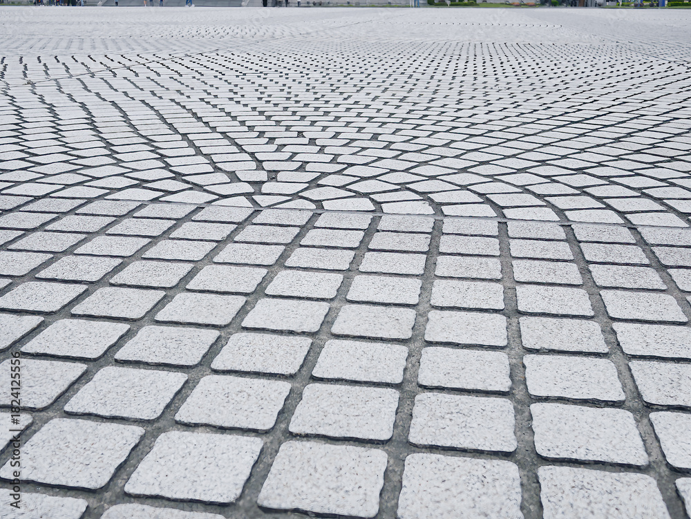 Fototapeta premium Grey cobblestone pavement texture with radial fan pattern