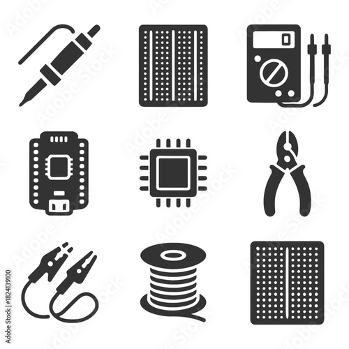 Essential electronics components and tools set: cables, boards, plier, chip, multimeter.