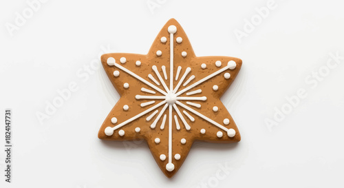 Star shaped gingerbread cookie with white icing decoration isolated on