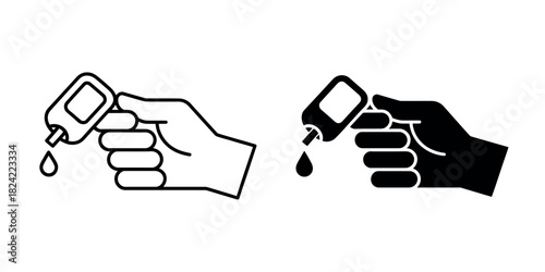 Hand squeezing a small bottle to dispense a drop of liquid