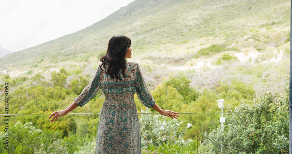 Obraz premium Back, woman and thinking on balcony at hotel for travel, scenic view and fresh air on holiday. Female person, vision or reflection and sightseeing on terrace, nature greenery and mountain on vacation