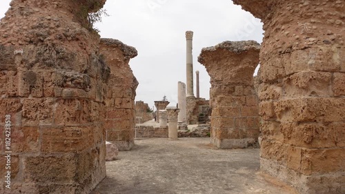 Walking through pillars of ancient city of Carthage, archaeology and historic landmark in Tunisia
