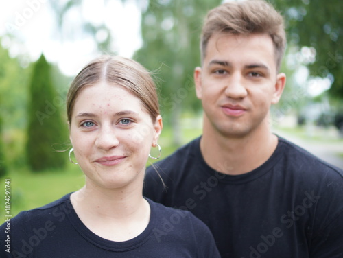 couple with dog, young  man with girl and with pomeranian spitz in the park portrait
