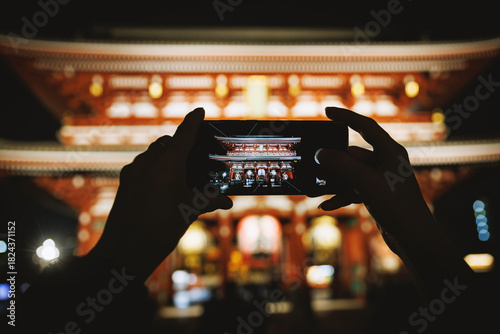 Photography Night photo of Japanese temple on smartphone screen
