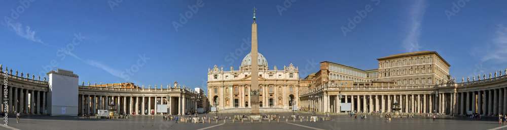 Fototapeta premium A panoramic view of St. Peter's Basilica and the historic architecture of the Vatican in Rome, Italy. The image captures iconic religious landmarks and ancient buildings in natural light.