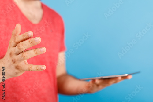 A man in a red shirt holds ...