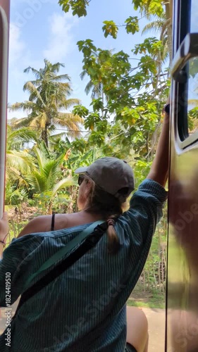Tropical train journey through Sri Lanka with lone caucasian woman smiling and seated inside old railway wagon, contemplative travel moment, slow transportation, Asia exploration and solitude