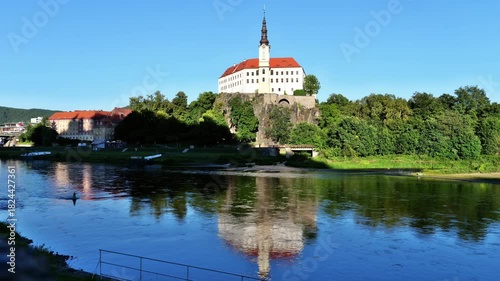 Panoramic view of the historic residence with Elbe River under a blue summer sky in northern Bohemia, Czechia