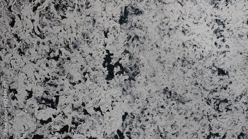 A dark glass surface covered with a swirl pattern of white oil or acrylic paint for an opaque effect, an abstract graphic design with a thick layer of paint on a smooth material