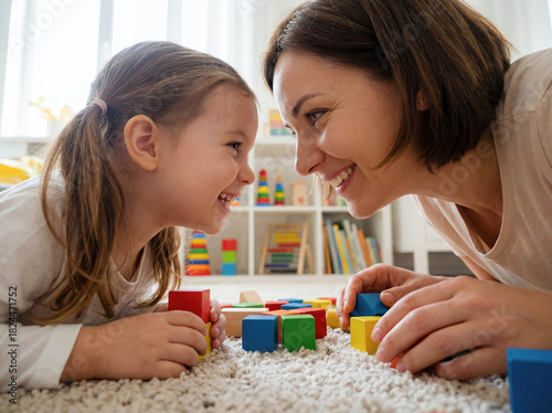 Child psychologist playing with little girl blocks floor play therapy mental health development support education guidance professional doctor kindness happy kid toy psychology