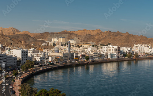 View of Mutrah Corniche with seaside promenade and rocky hills in Muscat
