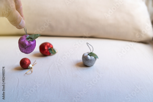 Christmas decoration with purple glitter apple and bows in the background