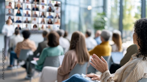 People attending hybrid business presentation, joining conference with online remote video call participants on large screen