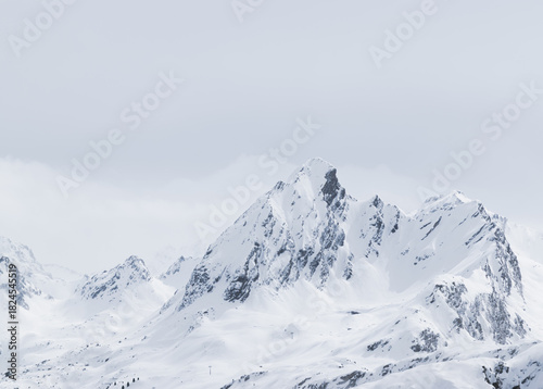 Wallpaper Mural Sharp snow-covered mountain peak under soft winter light with dramatic ridges and surrounding snowy terrain Torontodigital.ca