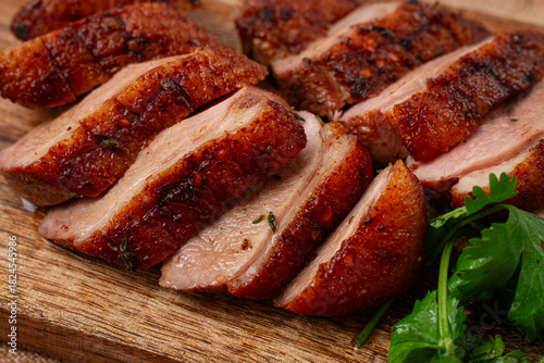Roast duck breast, sliced, on a wooden chopping board,close-up, no people,