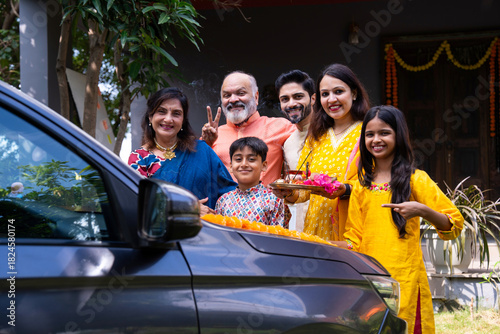 Tableau sur toile Indian family performing car puja ceremony to welcome their new vehicle with ble