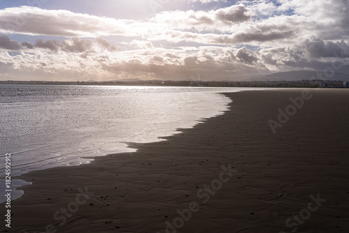Dramatic Sunlight Reflection on Sandymount Beach Shoreline at Low Tide, Dublin