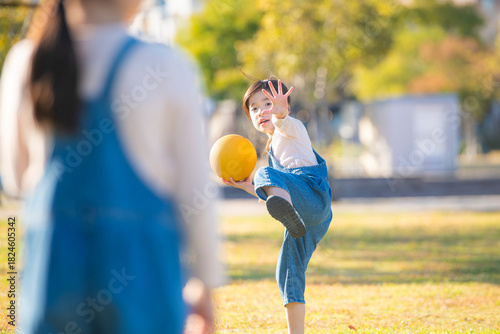公園でボールを投げる元気な女の子