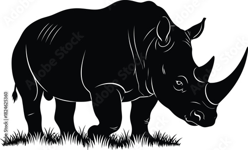 Black and white silhouette of a rhinoceros in a field of grass