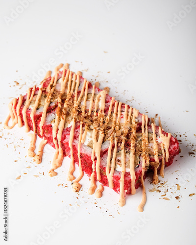 Elegant pastry presented with vibrant fruit coulis and glossy glaze