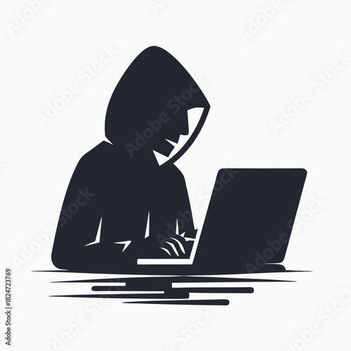 Dark hooded figure typing stealthily on a laptop screen in silhouette form