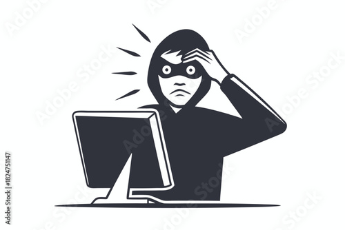 Frustrated hooded male stares at computer with his hand on head in despair