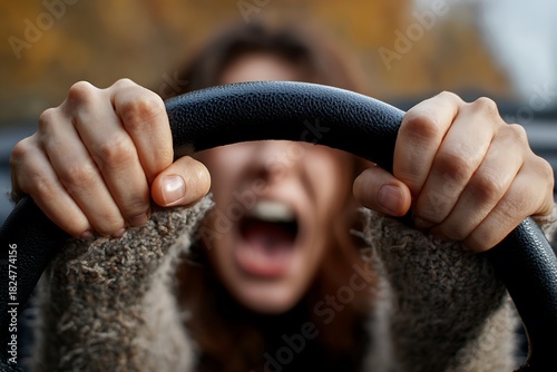 Woman screaming with road rage holding steering wheel