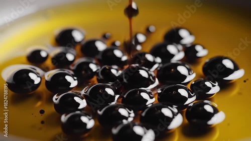 Close Up of Yellow Liquid with Dark Droplets Creating a Ripple Effect in Macro Photography