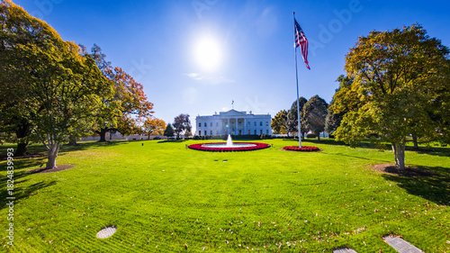 Iconic front view of the White House under sun and clear blue sky