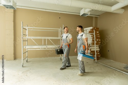 Two construction workers ar...