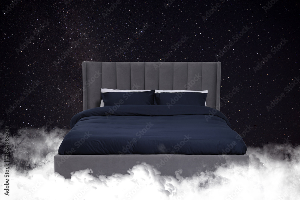 Fototapeta premium Large bed on fluffy clouds in starry night sky