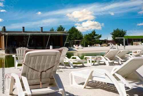 Wallpaper Mural White deck chairs at a recreation center with a freshwater lake Torontodigital.ca
