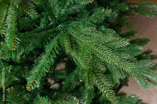 Realistic green artificial Christmas tree branches background