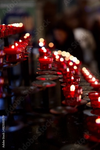 red votive candles on a prayer stand
