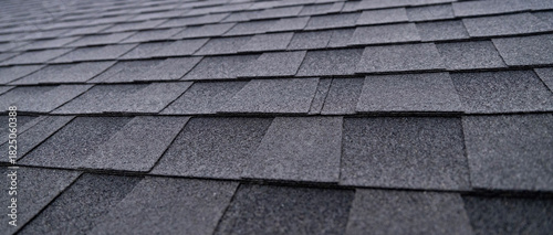 Selective focus texture of dark gray asphalt roof shingles