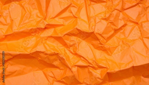 Orange wrinkled and creased paper texture background, abstract surface ideal for design and creative projects.