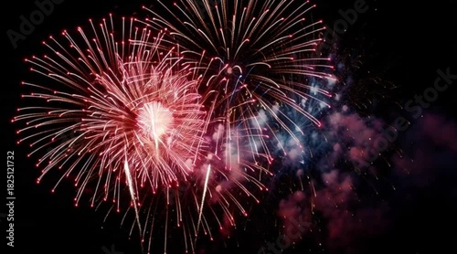 Vibrant fireworks exploding in the night sky create a stunning visual display for festive celebrations and patriotic events with dynamic, colorful bursts