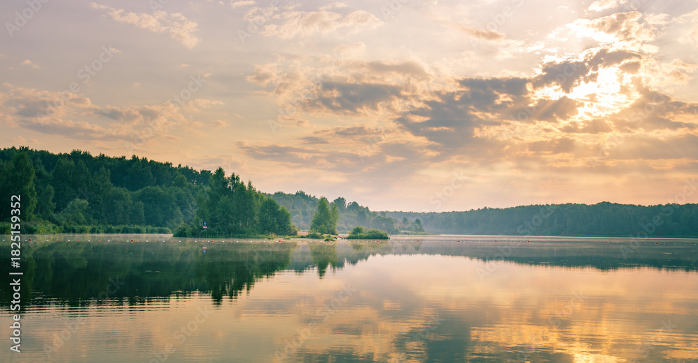 Fototapeta premium Lake with a cloudy sky in the background