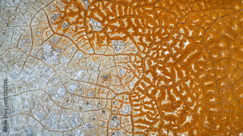 Aerial view of a parched landscape, where the earth's cracked surface reveals a stark contrast between mineral-rich deposits and arid terrain, Ríotinto, Andalusia, Spain.