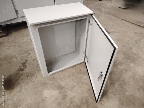 Sealed, wall mountable steel housing with a chrome locking handle, used to protect wiring, circuit breakers, or monitoring equipment from the elements.