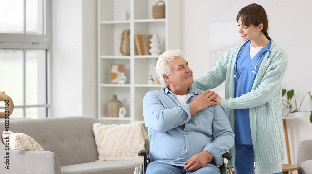 Fototapeta premium Female doctor hugging mature man in wheelchair at home