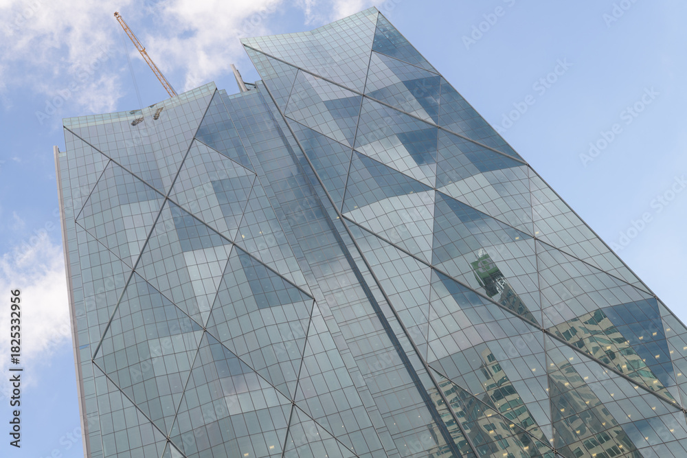 Fototapeta premium north facing elevation of CIBC Square complex, North Towers designed by WilkinsonEyre and Adamson Associates, in neomodern style with diamond-grid pattern on a blue sky in Toronto