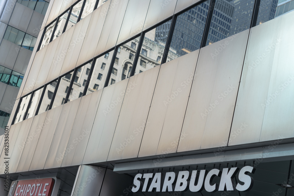 Fototapeta premium drop sign outside Starbucks, a coffee shop chain, located here at 123 Front St W, Citigroup Place, Toronto