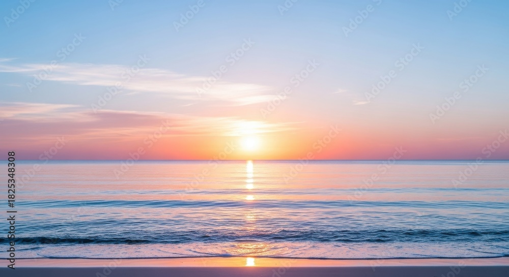 Naklejka premium Serene ocean sunrise with vibrant orange and pink hues reflecting on calm water surface above a sandy beach