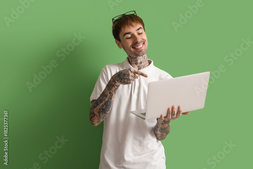 Happy young man with modern...