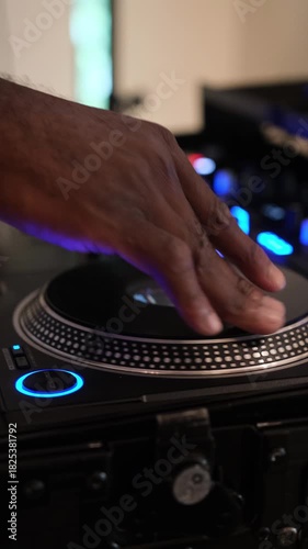DJ mixing on a turntable at a club