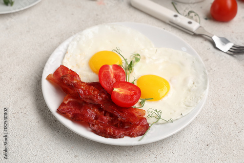 Plate with fried eggs, baco...