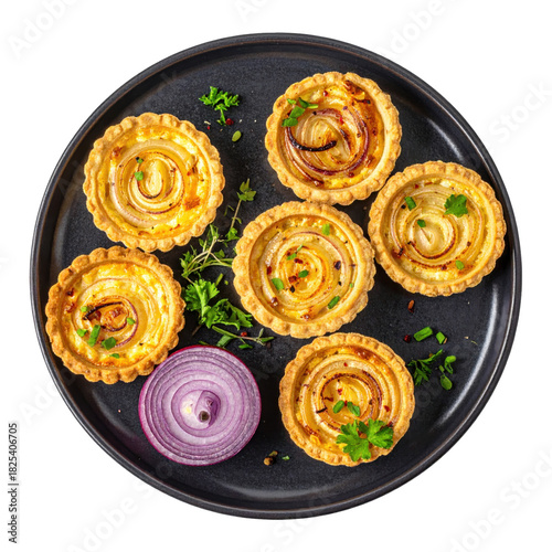 Caramelized onion and cheese tartlets, a classic french appetizer, served on a dark plate for elegant dining